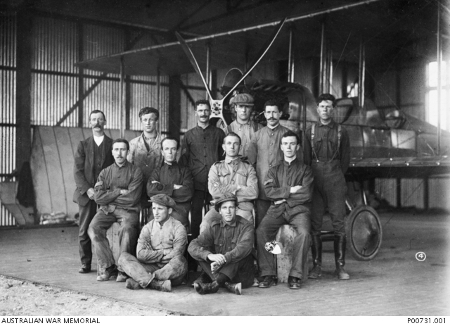 Trainees, instructors and administrative staff for the Australian Flying Corps first flying training course which began on August 17th, 1914. They are pictured in front of a B.E.2a aircraft in a hangar at the Central Flying School (Point Cook).