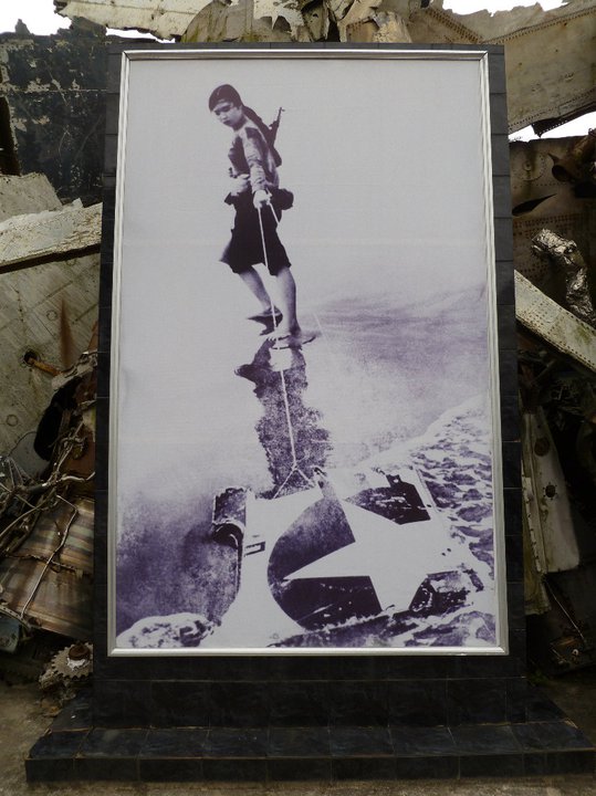 This is quite a dramatic photo of a woman dragging what appears to be part of a US Navy aircraft Vietnam War hanoi