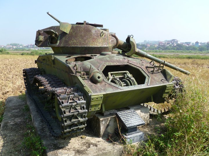 A smashed French Bison (M24 Chaffee) light tank in a field near the Dien Bien Phu airport in North Vietnam